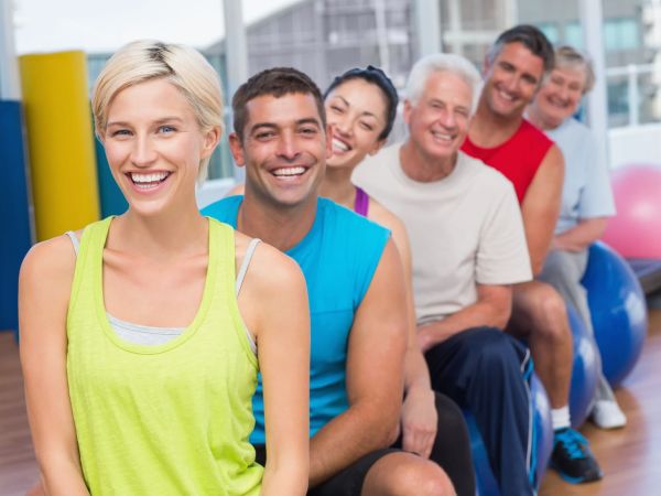 People relaxing on exercise balls in gym class